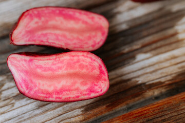 A detailed close-up of the internal texture of a red-skinned potato, showing bright pink marbling and a subtle natural surface texture.