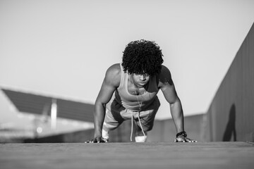 Focused man doing push-ups in black and white fitness shot