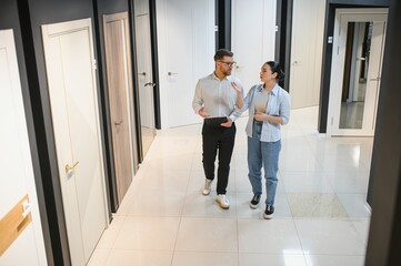 Female customer consulting with salesman in store