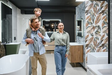 Family choosing bathroom fixtures in plumbing store