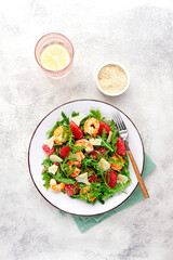 Fresh shrimp salad with arugula, grapefruit, and parmesan served in a bowl