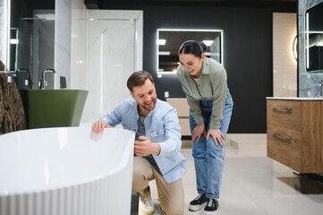 Couple exploring modern bathroom fixtures in store