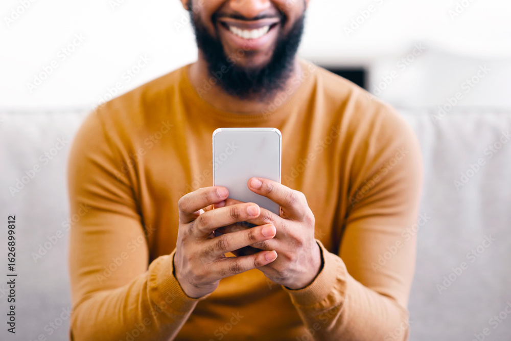 Poster unrecognizable african man using smartphone testing new mobile app, texting and browsing internet si