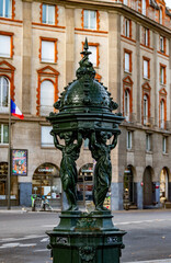 Fototapeta premium Detailed shot of a green Wallace Fountain, representing public access to water in the heart of Paris