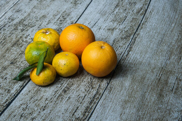 Variety of fruits including , oranges, grapefruits and hibiscus flowers on the table