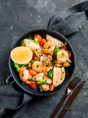Salad with Mixed Seafood on dark plate