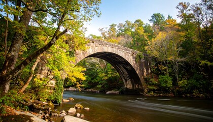 Autumnal stone arch bridge over a flowing river