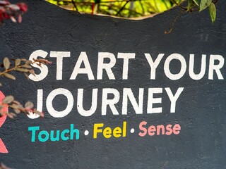Start your journey by touching, feeling, and sensing colorful signs on the wall in the garden.