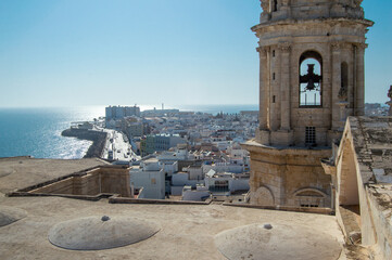 Elevated view of Cadiz Cathedral bell tower overlooking coastal town and Atlantic Ocean in Spain © Sara