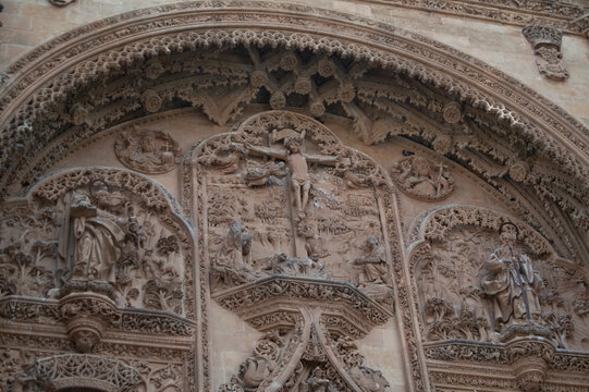 Stone carved relief of the Crucifixion on the historic plateresque facade of the University of Salamanca in Spain