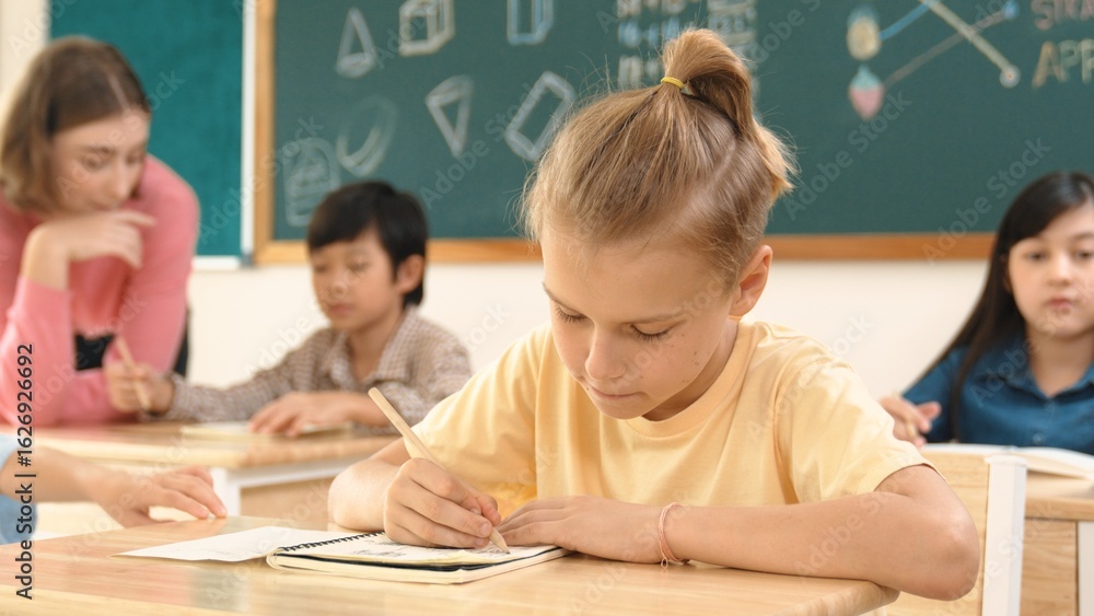Poster stressful student focus on doing test while sitting in front of blackboard while multicultural child