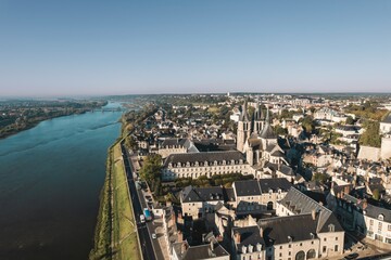Fototapeta premium An elevated perspective overlooking the charming Chaumont-sur-Loire, France. The Loire River flows past the city, with the magnificent Chateau de Chaumont rising above the rooftops