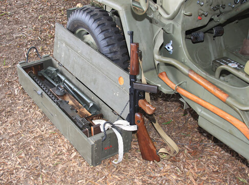 Thompson SMG And Crate 30 Caliber Machine Gun By Military Jeep Front Wheel