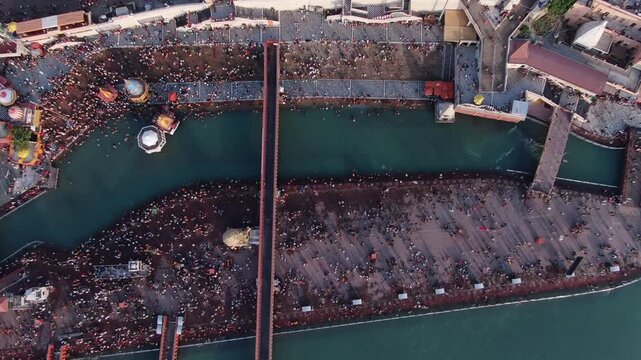4k Aerial Drone shot of huge crowd at river ganges  har ki pauri  during a hindu festival Kumbh Mela in Haridwar , Uttarakhand,India 
