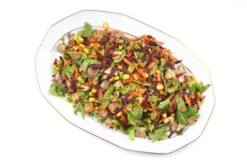 Mixed fresh Turkish salad. Carrots, arugula, cucumber, basil, pepper, black cumin, pepper, corn and plenty of olive oil in a serving plate. Healthy summer food.
