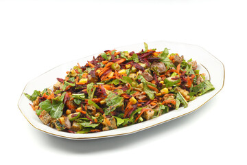 Mixed fresh Turkish salad. Carrots, arugula, cucumber, basil, pepper, black cumin, pepper, corn and plenty of olive oil in a serving plate. Healthy summer food.