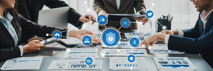 A dynamic business meeting focusing on data protection and cybersecurity. The collaborative team analyzes strategies using technology solutions and discusses security measures effectively. Amity