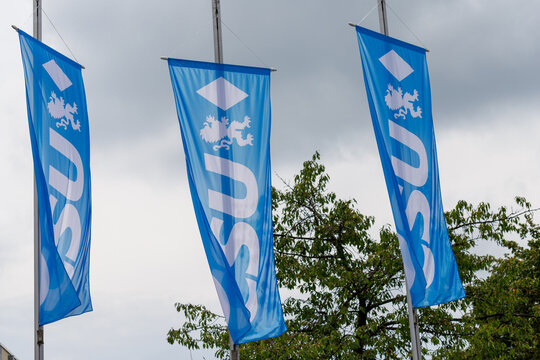 Three Blue CSU Flags Hanging Outdoors