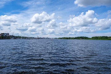 Harbor and waterfront view under a cloudy sky - Rostock, Germany