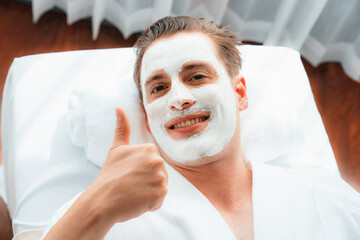 Serene ambiance of spa salon, man customer indulges in rejuvenating with luxurious face cream...