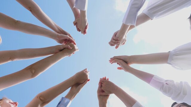 A collective of hands reaching skyward, symbolizing unity and collaboration in a vibrant atmosphere.