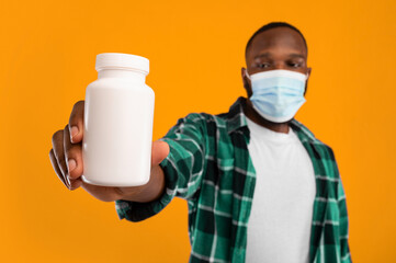 Flu Medicine Treatment. Black Man Showing Bottle Of Medication Pills To Camera Recommending Cure...