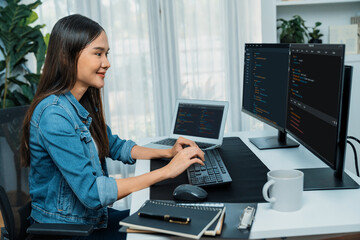 Young Asian in IT developer creating with typing online information on pc with coding program data...