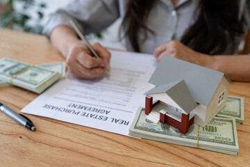 Signing a real estate purchase agreement. Concept of buying a new house and paying with cash.