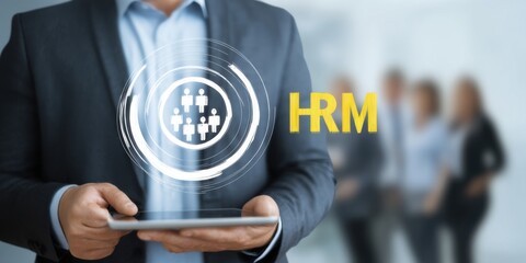 Business professional using tablet for human resource management in modern office setting with team in background inscription HRM