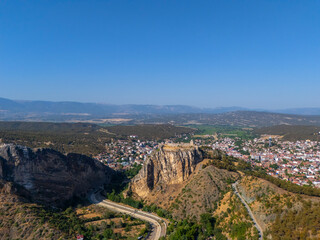 Aerial wide-angle view of Boyabat Castle rising above a steep cliff in Sinop, Turkey. The fortress...