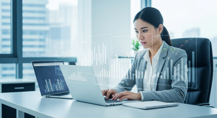 Focused businesswoman analyzes financial data on laptop in modern office.