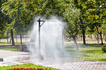 Water spray frame for cooling in hot weather on city street in Kyiv, Ukraine. Water mist cooling...