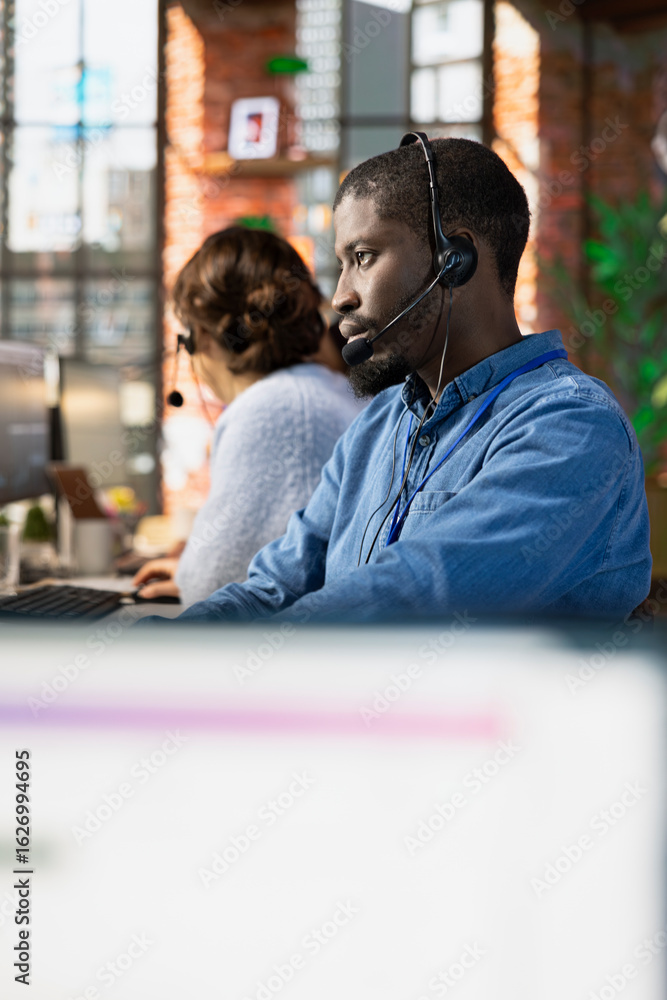 Poster helpful call center agent at office desk handling customer inquiries, complaints and support request