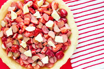 Strawberry and rhubarb pie filling in bottom crust.