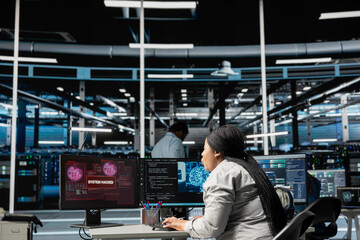 Artificial intelligence data center system administrator disturbed by virus breaching security. African american woman in AI server hub afraid by hacker attack stealing sensitive information.