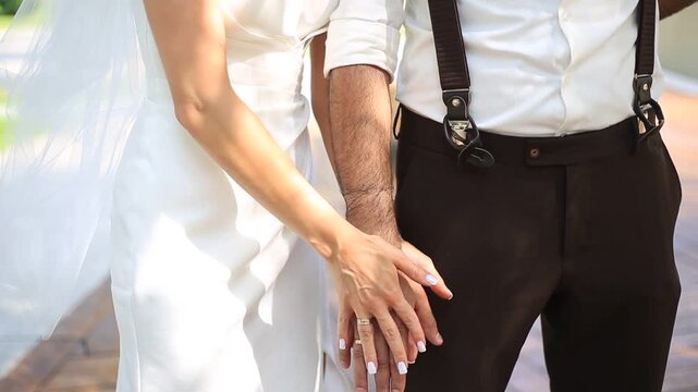 bride and groom holding hands
