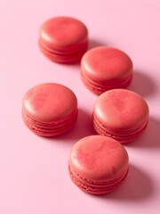 Fototapeta premium Delicious Coral Macarons Arranged Artistically on a Soft Pink Background, A Sweet Treat for Any Occasion