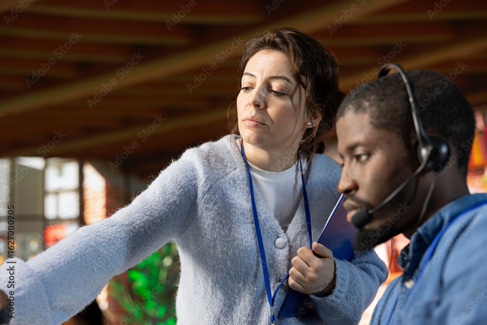 Poster call center onboarding specialist training staff member on how to use computer software. close up of