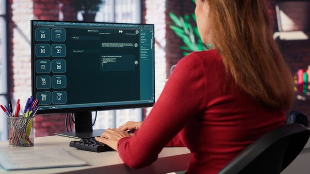 Online interaction with an AI chatbot system on a desktop setup, woman using technology evolution, virtual assistance and automated dialogue for data driven productivity and innovation. Camera A.