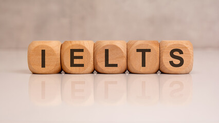IELTS word spelled on wooden cubes with clean background