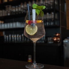 a cocktail with lemon and berries