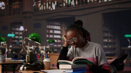 Exhausted student falling asleep while she reads for periodical exams at the college, working hard for diploma with excellent marks. Tired pupil studying all night before first grade. Camera B.