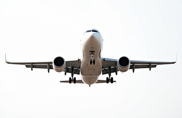 Fototapeta premium Front view of airplane isolated on white background. White plane in sky. Commercial airliner landing. Aviation transport, travel, industry, airline, air travel concept. Passenger jet, plane flying in