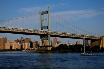 New York City Bridge With Sailboat on Sunny Day (Queens, New York, USA)
