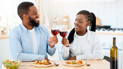 Quarantine Dates. Happy Black Couple Drinking Red Wine And Having Lunch At Home, Loving African American Spouses Sitting At Table In Kitchen, Enjoying Spending Time Together, Closeup Shot