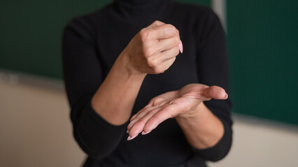 Woman showing grant sign in sign language. 
