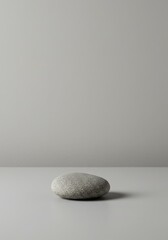 Smooth Gray Stone Resting on a Neutral Surface