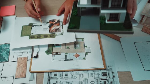 A vibrant workspace filled with colorful design layouts and swatches, showcasing teamwork in the creative process of interior design, blending artistic ideas and modern aesthetics. SACTR