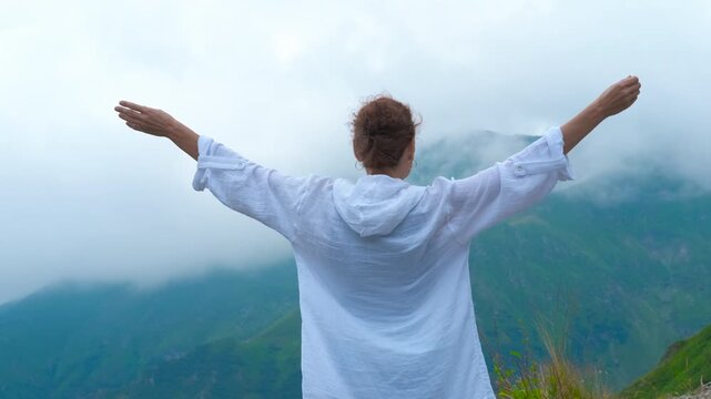 Traveler lady facing the europe mountains. A woman traveler facing the fogy mountains during summer trip