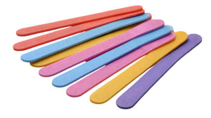 A colorful assortment of craft sticks arranged on a black background in a close up studio shot